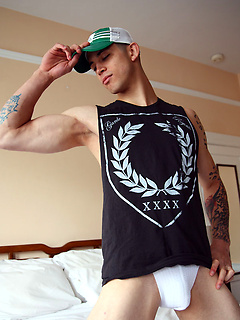 Tattooed stud shows his abs and fat cock