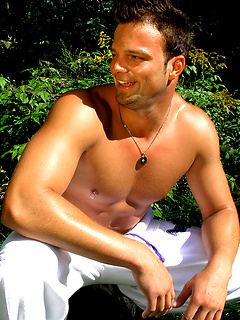 Ricky M's muscles glisten in the sun before he goes inside to play with his dick