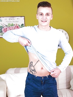 Tattooed Dom Ully busts a big nut over his stomach.