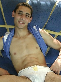 Hot twink covers his smooth stomach with a hot gooey load.